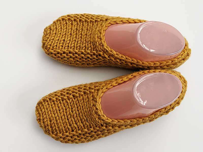 hand knitted slippers pattern in mustard yellow yarn