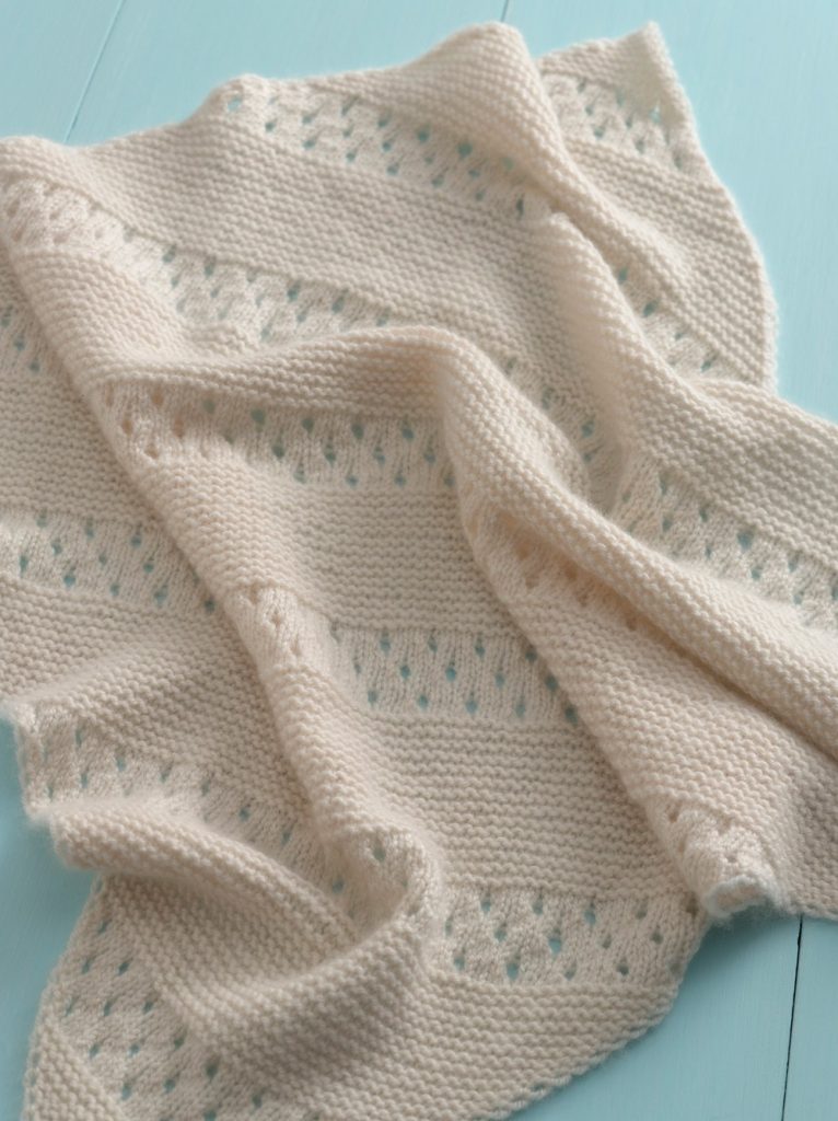 diagonal eyelet baby afghan knitting pattern features knit yarnover eyelets and k2togs with wide garter stitch sections