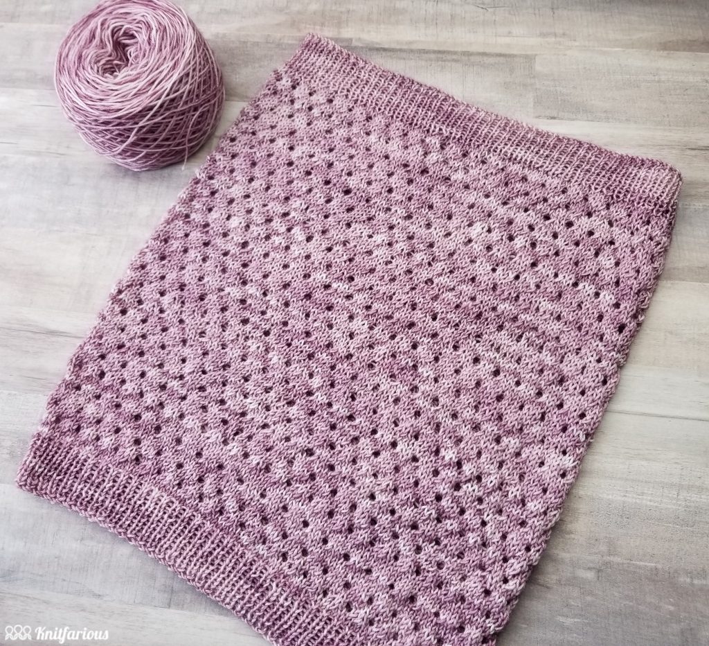 pink knit cowl featuring knit eyelets and ribbed edges
