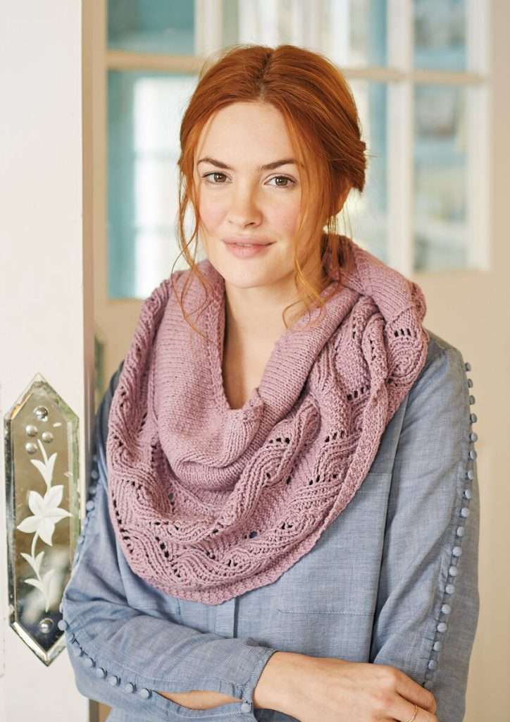 knitted pink shawl in worsted weight yarn featuring stockinette stitch and lovely lace border.