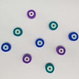evil eye stitch stoppers in blue, teal, and purple