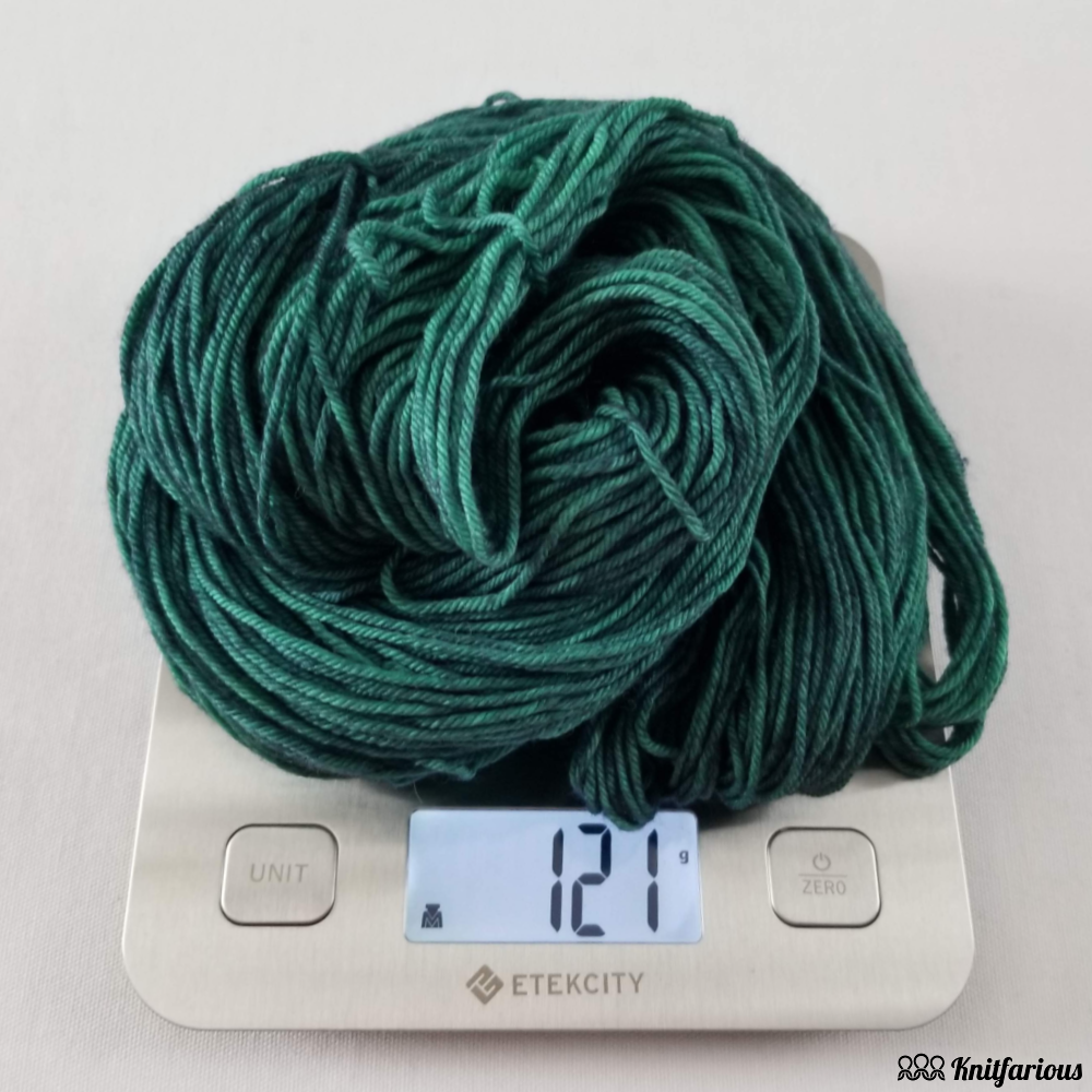 weighing skein of yarn on food scale in grams