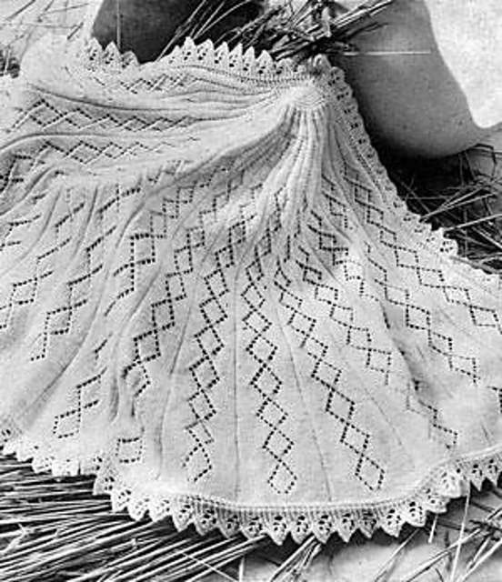 black and white photo of semi-circular shawl knitting pattern featuring diamond lace pattern